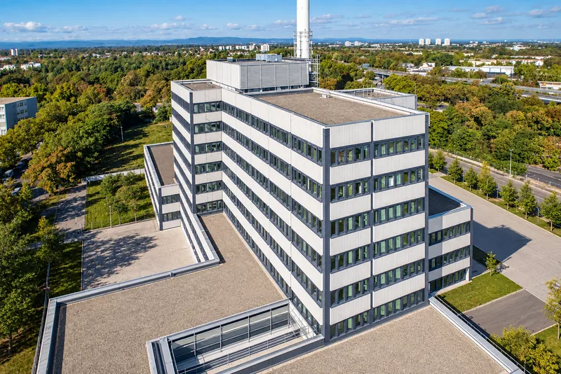 Oblique aerial view of the high-rise with the transmission mast on the roof