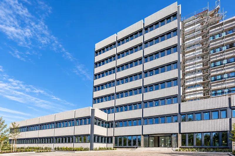 High-rise during the retrofit: finished on the left, still scaffolded on the right